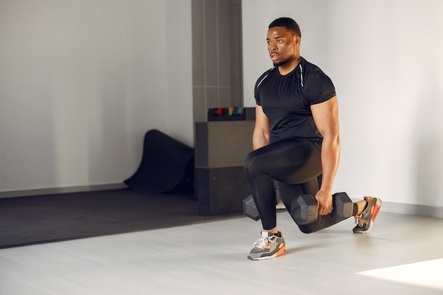 A handsome black man is engaged in a gym