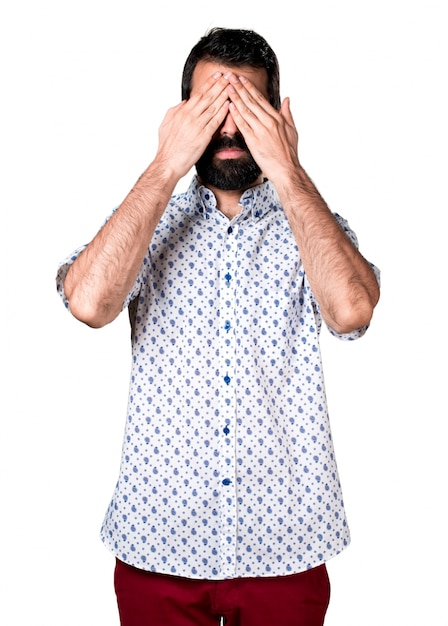 Handsome brunette man with beard covering his eyes