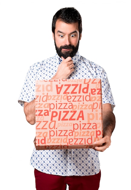 Free photo handsome brunette man with beard holding a pizza