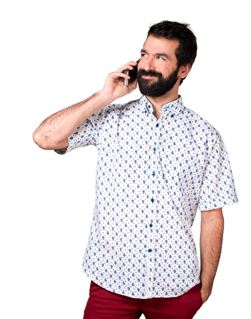 Handsome brunette man with beard talking to mobile