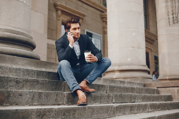 Handsome businesman in a summer city