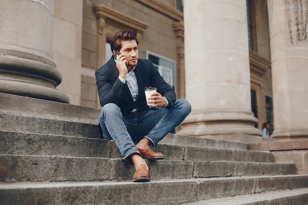 Handsome businesman in a summer city