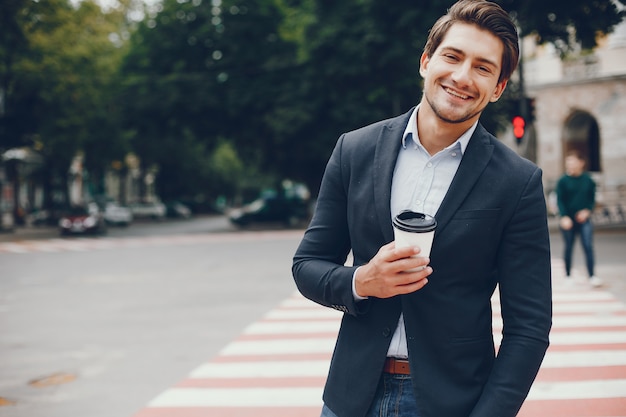 Handsome businesman in a summer city