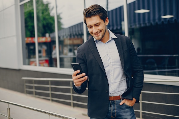 Handsome businesman in a summer city