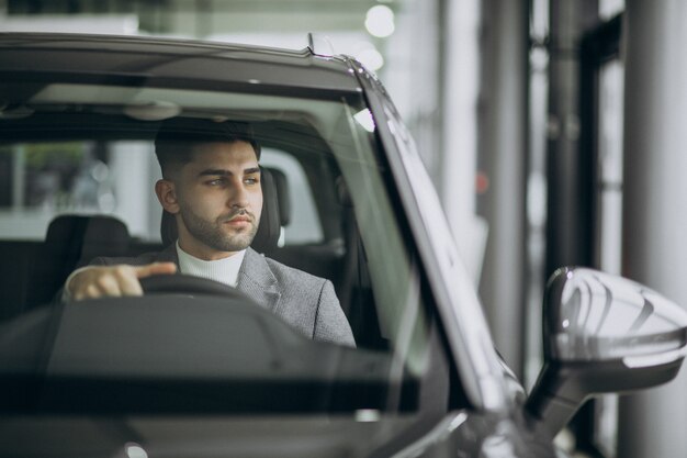 Handsome business man driving in car