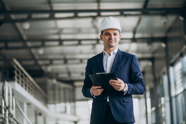 Free photo handsome business man engineer in hard hat in a building