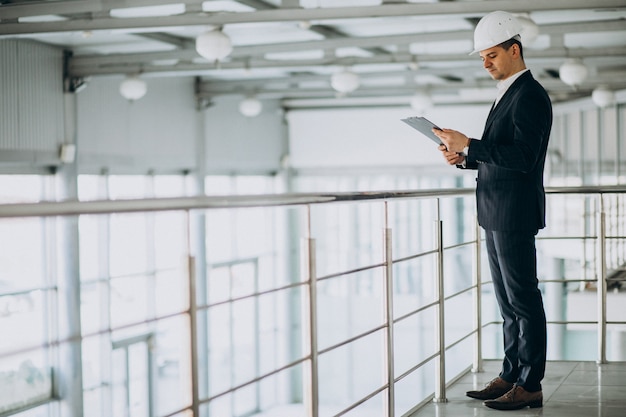 Handsome business man engineer in hard hat in a building