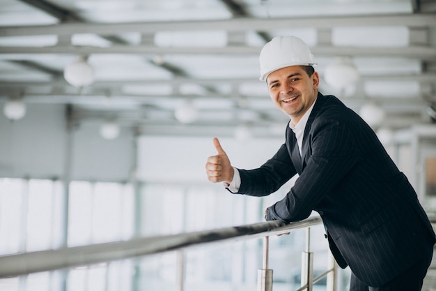 Handsome business man engineer in hard hat in a building