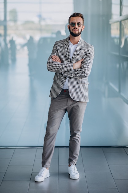 Free photo handsome business man standing in office