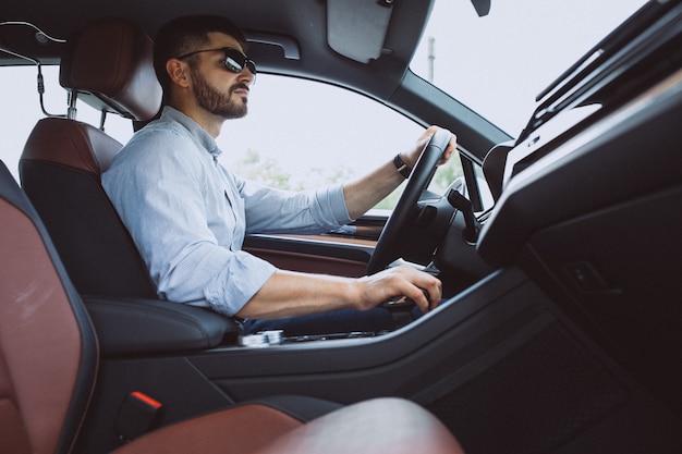 Handsome business man travelling in a car