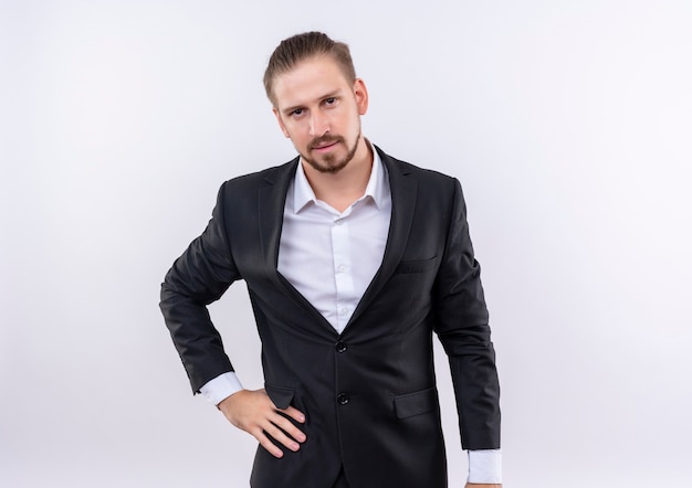 Free photo handsome business man wearing suit looking at camera with serious confident expression standing over white background