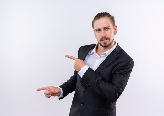 Handsome business man wearing suit standing over white background