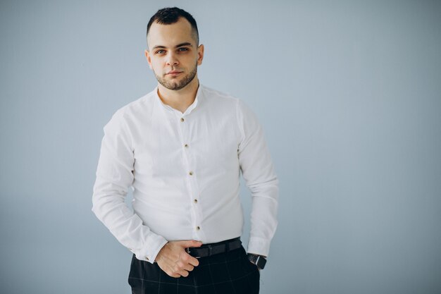 Handsome business man in white shirt isolated in office