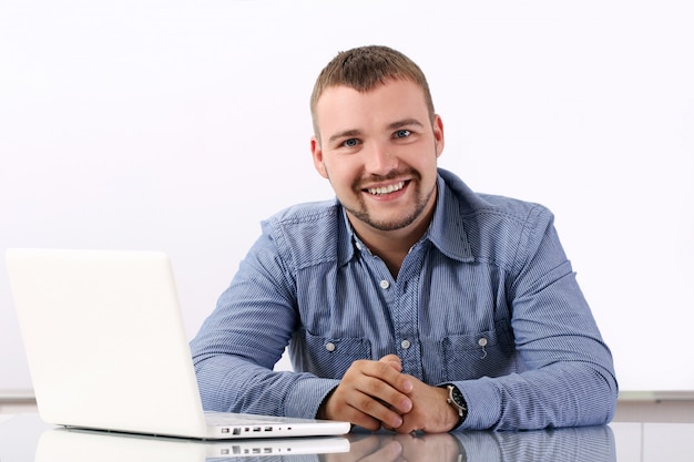 Free Photo handsome businessman at his workplace