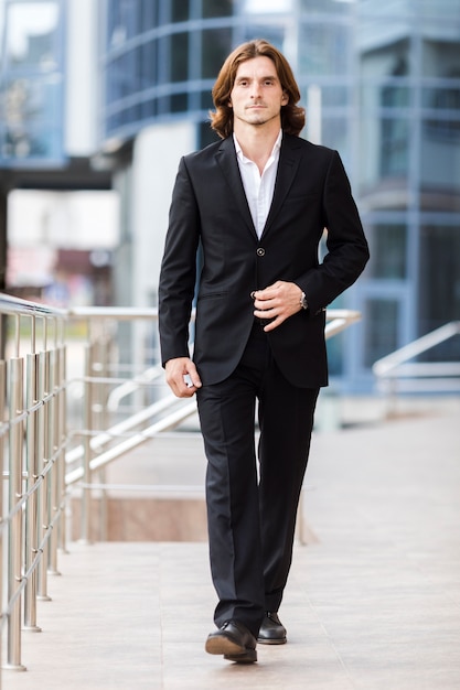 Free Photo handsome businessman walking to camera