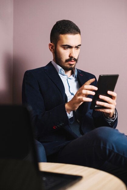 Handsome businessman watching tablet