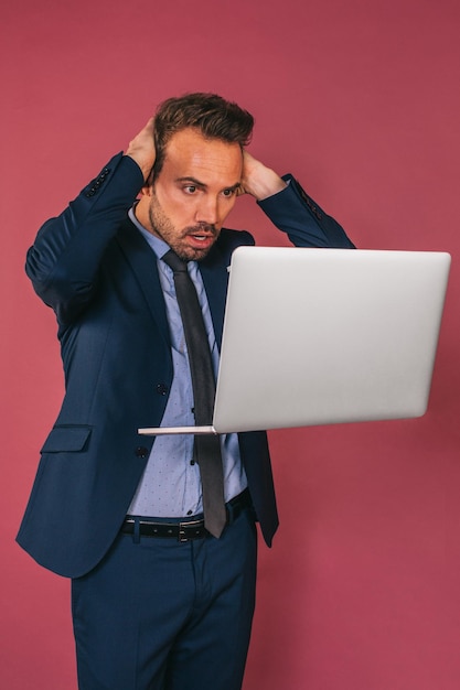 Free Photo handsome businessman working in a laptop