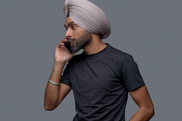 Free photo handsome calm focused male calling on his smartphone