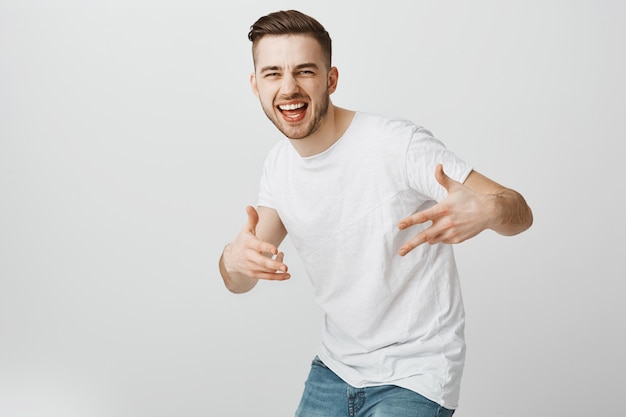 Handsome carefree guy dancing hip hop and having fun