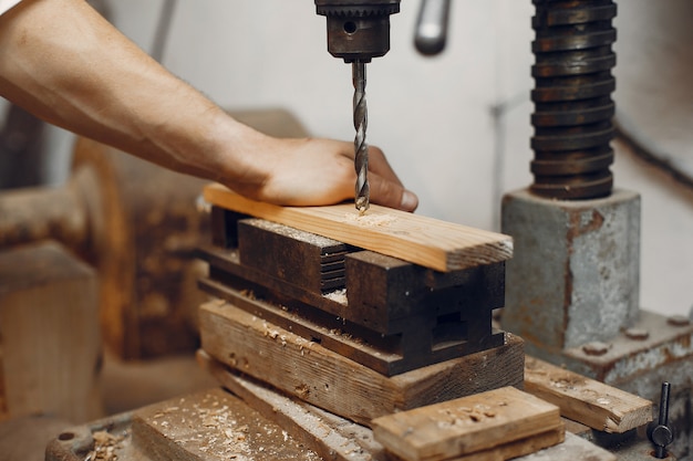 Free photo handsome carpenter working with a wood