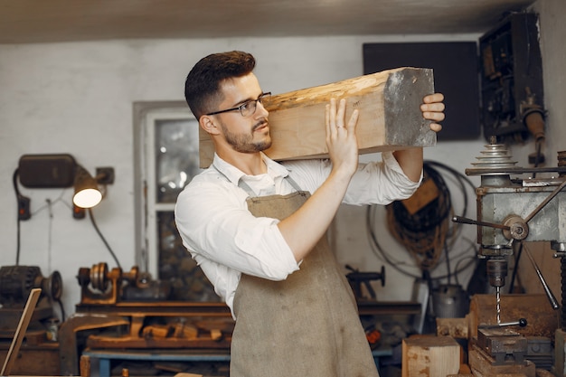 Free Photo handsome carpenter working with a wood