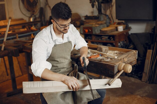 Handsome carpenter working with a wood