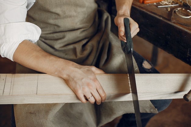 Handsome carpenter working with a wood