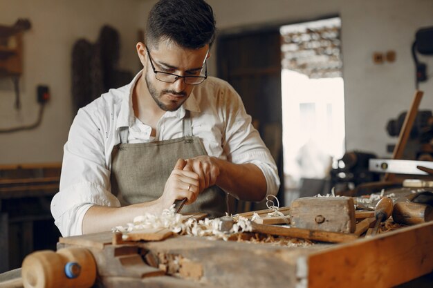 Handsome carpenter working with a wood