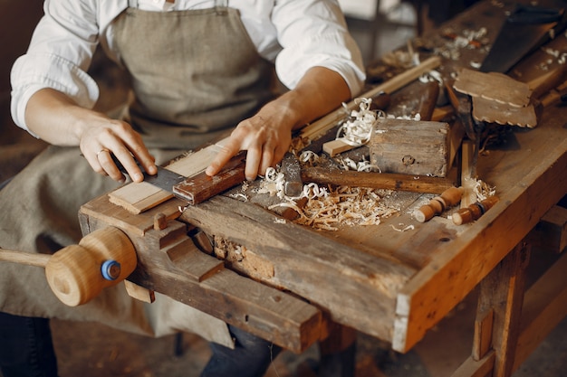 Free Photo handsome carpenter working with a wood