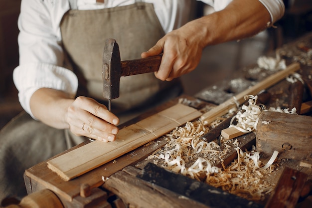 Free photo handsome carpenter working with a wood