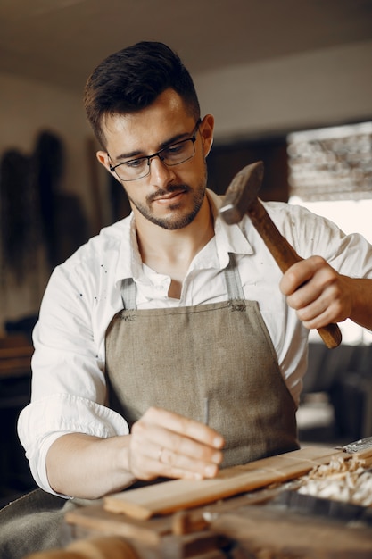 Handsome carpenter working with a wood