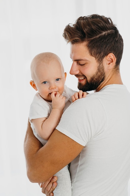 Handsome dad holding his baby