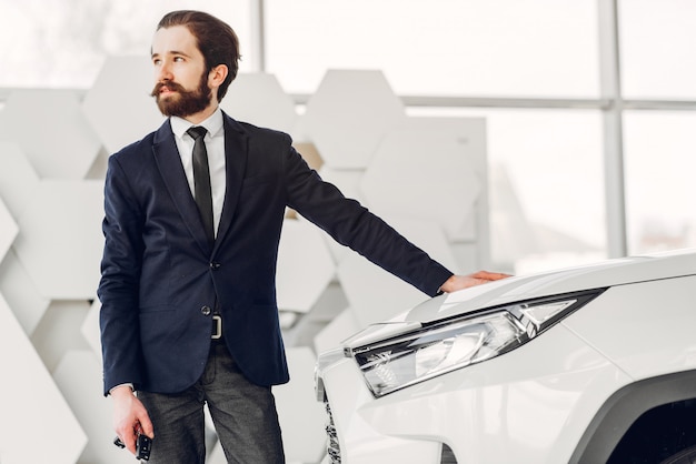 Free Photo handsome and elegant man in a car salon