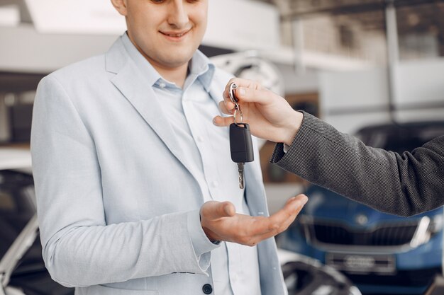 Handsome and elegant man in a car salon