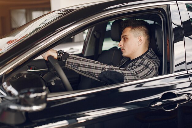 Handsome and elegant man in a car salon