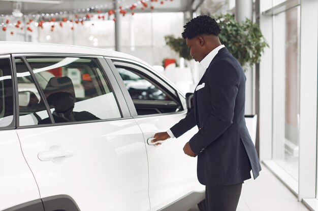 Handsome and elegant man in a car salon