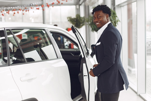 Handsome and elegant man in a car salon