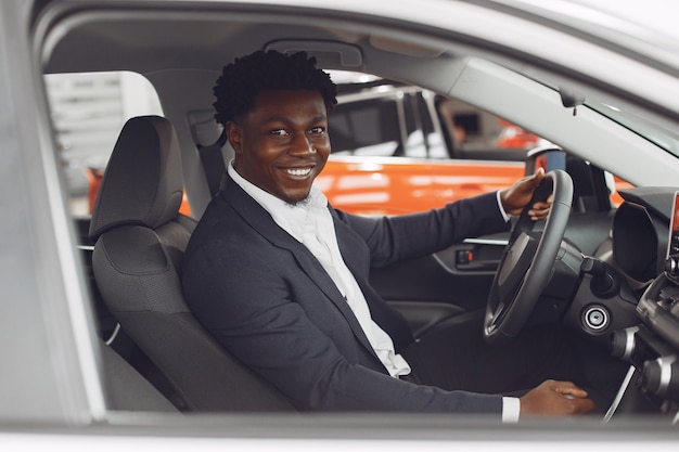 Handsome and elegant man in a car salon