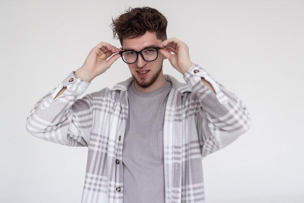 Handsome guy in glasses and white shirt isolated on white background