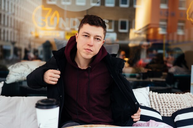 Handsome guy hanging out in an outdoor cafe