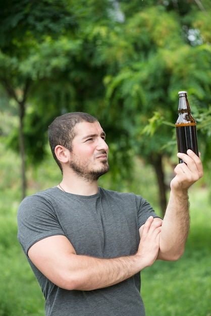 Handsome guy looking at beer