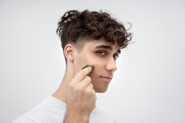 Handsome guy massaging his face