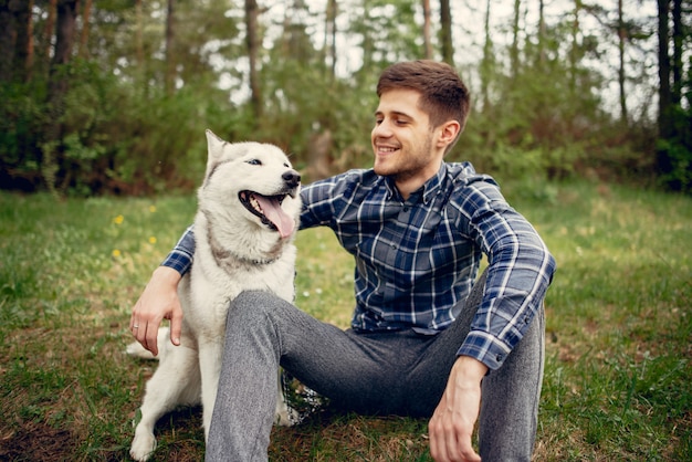 Handsome guy in a summer park with a dog