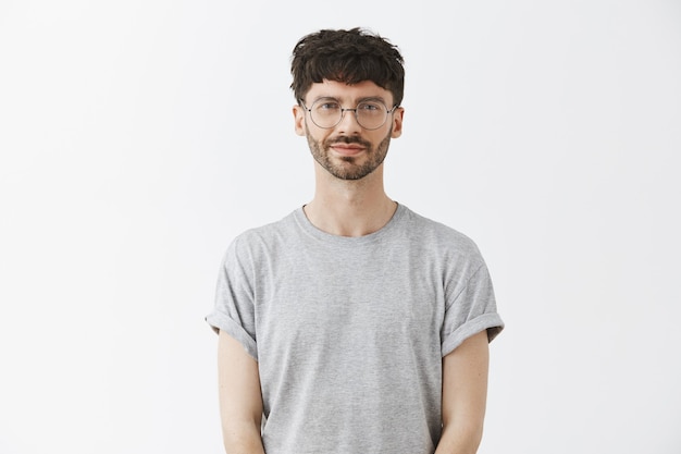 Handsome handsome guy posing against the white wall