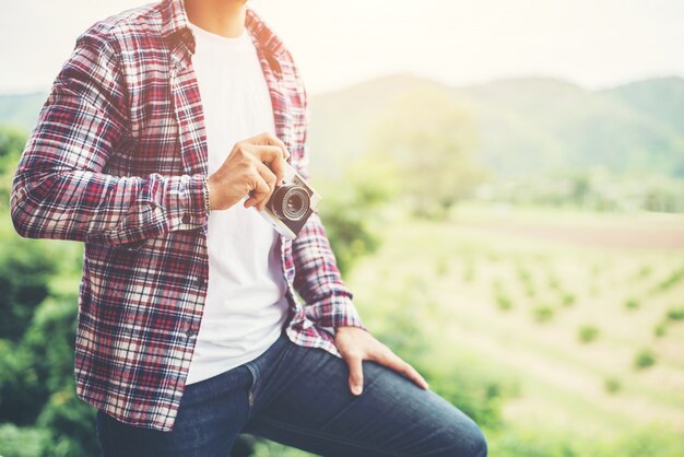 handsome hipster bearded man with cup of morning coffee walking