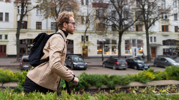 Free photo handsome male riding an electric scooter