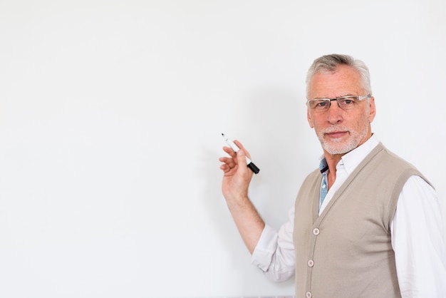 Handsome male with marker and looking at camera