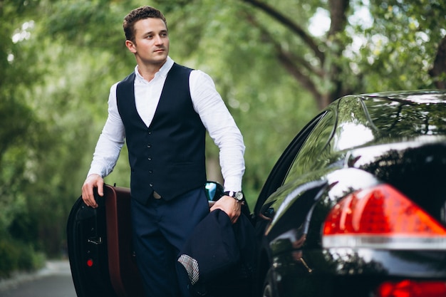 Handsome man by car