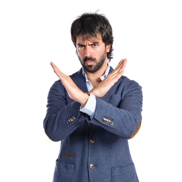 Handsome man doing NO gesture over white background