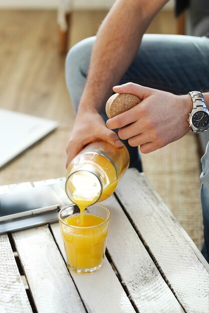 Handsome man drinking orange juice